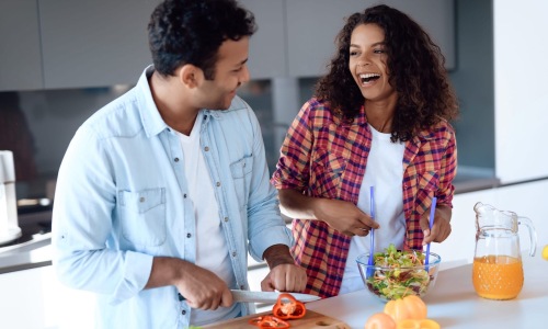 a couple in a kitchen