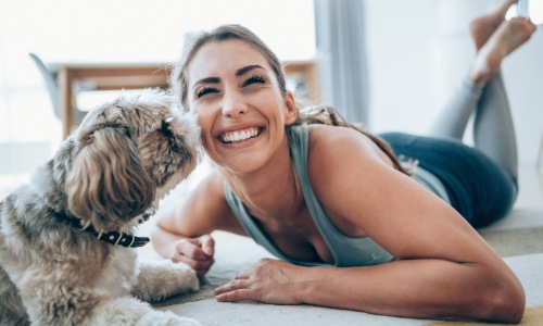 a woman and a pet indoors